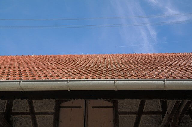 Clay tile roof with metal gutters