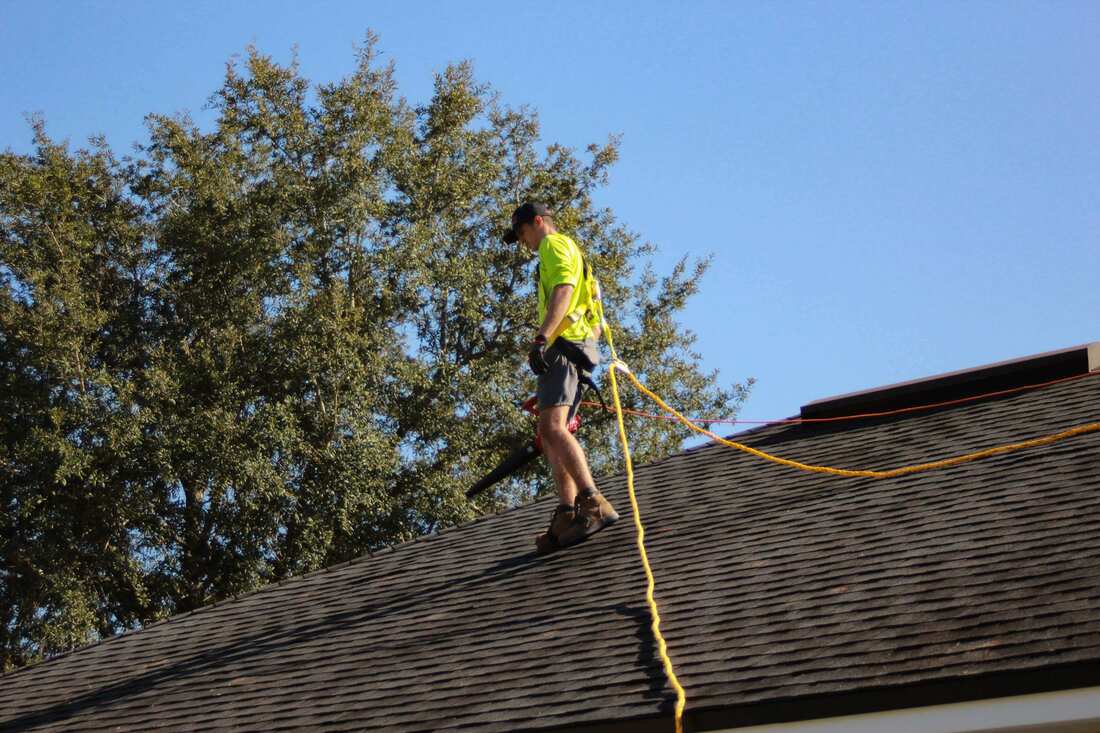 Man on roof with extension cord